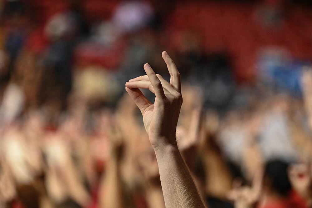 A student in the band holds up a "wolfie" during exhibition&#160;the game against Anderson in Reynolds Coliseum on Tuesday, Oct. 29, 2024. The Wolfpack beat the Trojans 91-54.