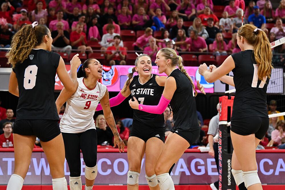 The NC State volleyball team celebrates a point during the annual Pink Match against Duke in Reynolds Coliseum on Sunday, Oct. 13, 2024. NC State beat Duke 3-0.