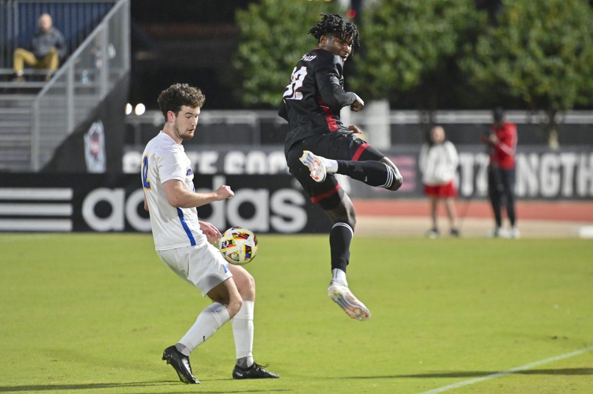 Sophomore forward Donavan Phillip jumps and kicks the ball during the men's soccer game against Hofstra at Dail Soccer Field on Tuesday, Oct. 15, 2024. Phillip attempted one shot on the goal. NC State tied with Hofstra 1-1.