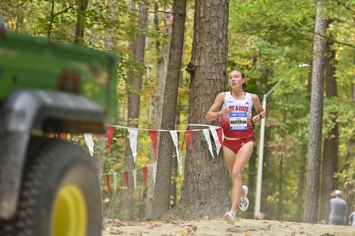 Junior runner Grace Hartman follows behind the four-wheeler during the Cross Country ACC Championship at WakeMed Soccer Park on Friday, Nov. 1, 2024. Hartman finished first with a time of 19:15.1. The NC State women's team finished in fifth place.