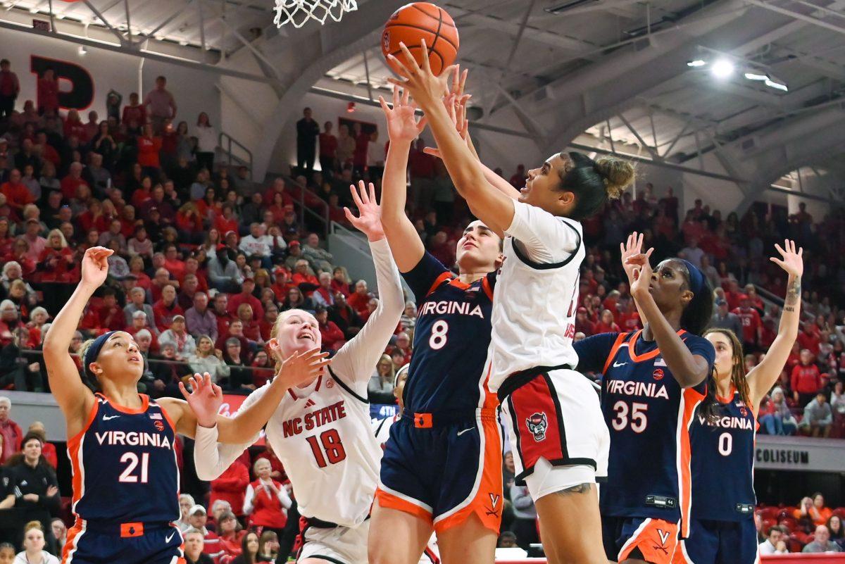 Graduate guard Madison Hayes attempts to shoot the ball during the game against University of Virginia in Reynolds Coliseum on Sunday, Jan. 19, 2025. Hayes scored 19 points and made 11 rebounds. NC State won the game against UVA 73-68.