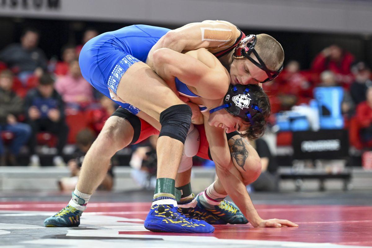 Redshirt senior Kai Orine wrestles his opponent during the duel against Duke in Reynolds Coliseum on Friday, Jan. 10, 2025. NC State beat Duke 47-0.