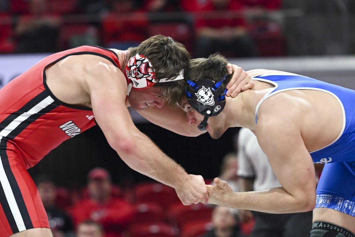 Redshirt junior Isaac Trumble lock arms with his opponent during the duel against Duke in Reynolds Coliseum on Friday, Jan. 10, 2025. NC State beat Duke 47-0.