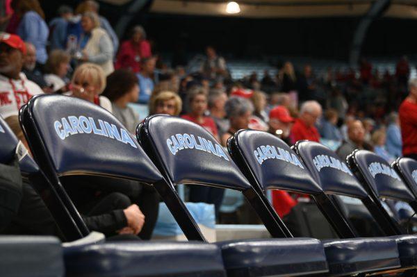 Empty chairs line the NC State bench before tipoff against UNC on Sunday, Feb. 16, 2025, in Carmichael Arena. UNC defeated NC State 66-65.