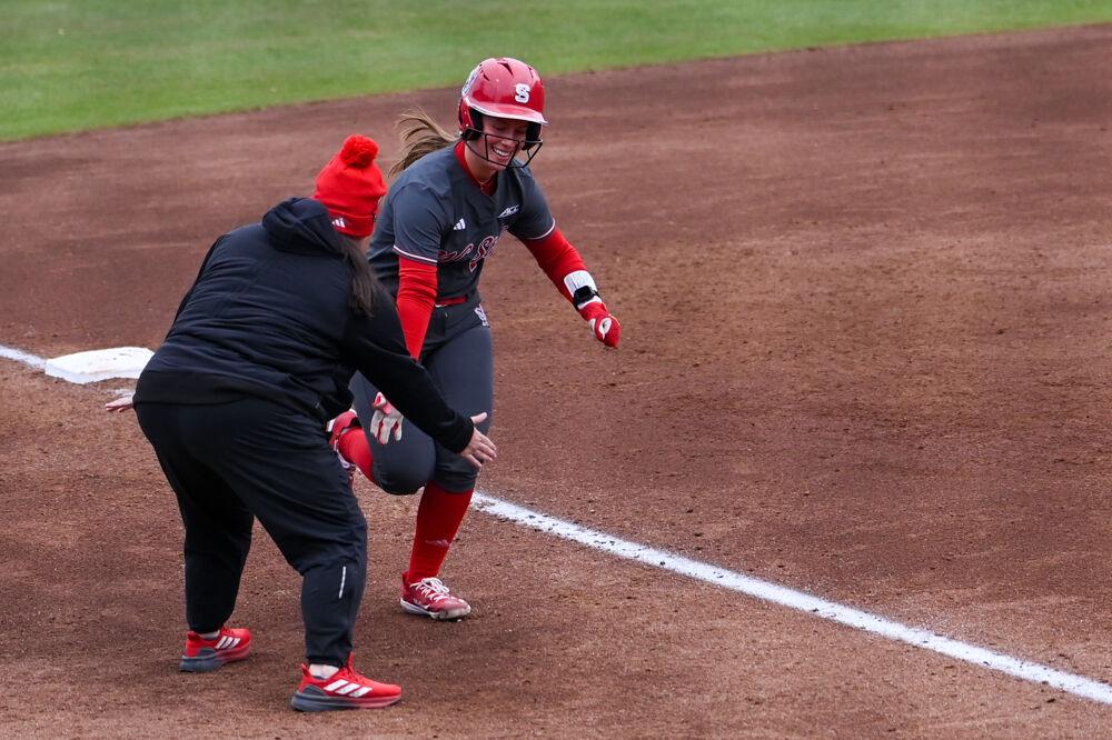 Junior catcher Ellington Whitaker high-fives head coach Lindsay Leftwich as she runs home during the game against Central Michigan at Dail Softball Stadium on Saturday, Feb. 22, 2025. The Wolfpack beat the Chippewas 6-5.