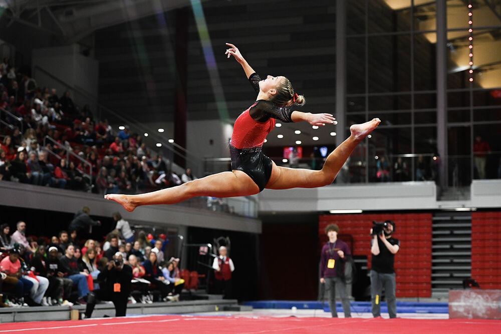 Junior Kailee Adomaites performs a midair split during the meet against Ohio State in Reynolds Coliseum on Friday, March 7, 2025. Adomaites scored 9.425 on her exhibition floor routine. NC State beat Ohio State 197.000-196.325.