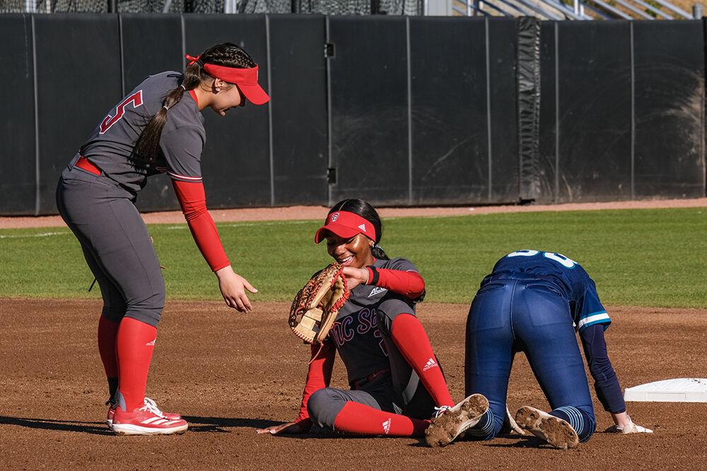 Freshman infielder Kendall Simmers helps junior utility player MaKayla Marbury get up from the ground during the game against UNC-Wilmington at Dail Softball Stadium on Feb. 28, 2025. Simmers and Marbury had a combined two hits during the game. NC State lost to UNC-Wilmington 5-4.