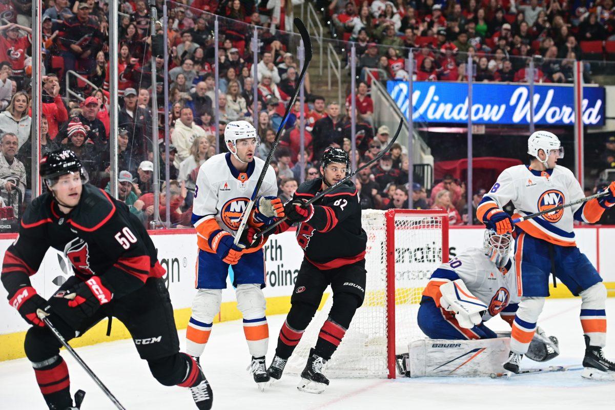 Center Jesperi Kotkaniemi battles an opponent during the game versus the New York Islanders at the Lenovo Center on Sunday, March 30, 2025. The Hurricanes beat the Islanders 6-4.