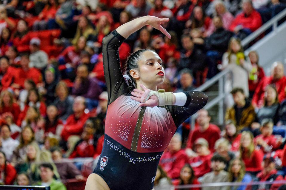 Graduate Chloe Negrete poses on the balance beams during the meet against UNC-Chapel Hill at Reynolds Coliseum on Friday, Feb. 21, 2025. Negrete scored a 9.975 on the floor exercise. NC State beat UNC 197.025-195.500.