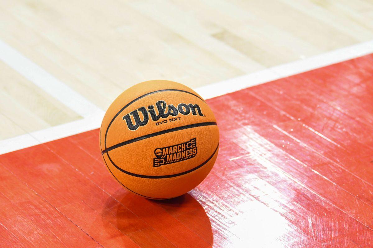 A March Madness basketball rolls across the court during the first round game of the NCAA Tournament against Vermont in Reynolds Coliseum on Saturday, March 22, 2025. NC State won the game 75-55.