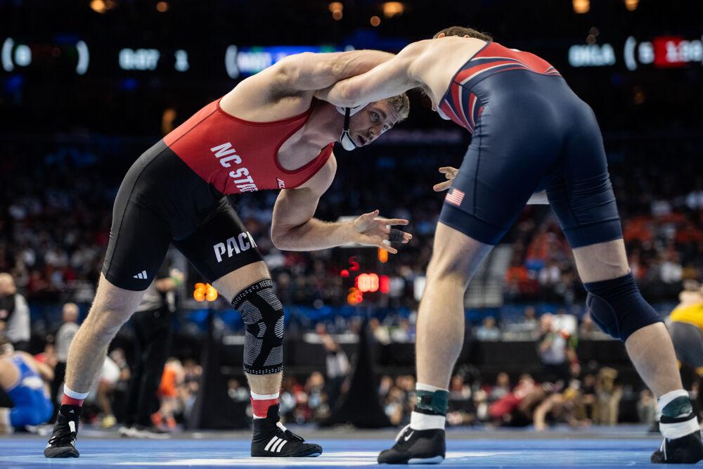 Redshirt sophomore Dylan Fishback keeps his opponent at a distance during the first round of the NCAA Wrestling Championship Tournament in Wells Fargo Center on Thursday, March 20, 2025.