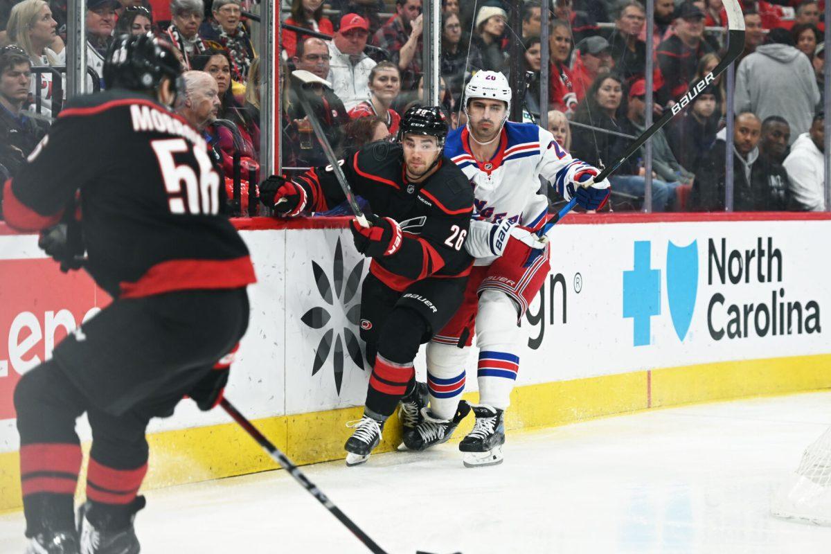 Defenseman Sean Walker guards an opponent during the game versus the New York Rangers at the Lenovo Center on Saturday, April 12, 2025. The Hurricanes beat the Rangers 7-3.