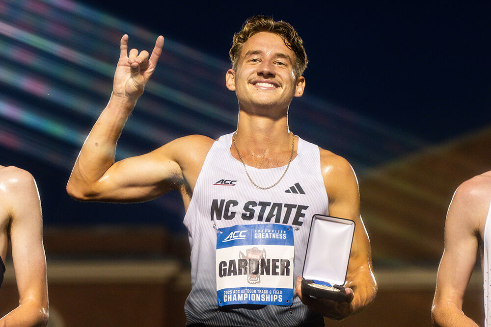 Junior distance runner Brett Gardner holds up a "wolfie" after winning the men's 3000m steeplechase during the ACC Outdoor Track and Field Championships in Kentner Stadium on Friday, May 16, 2025. Gardner won the championship with a time of 8:40.55.