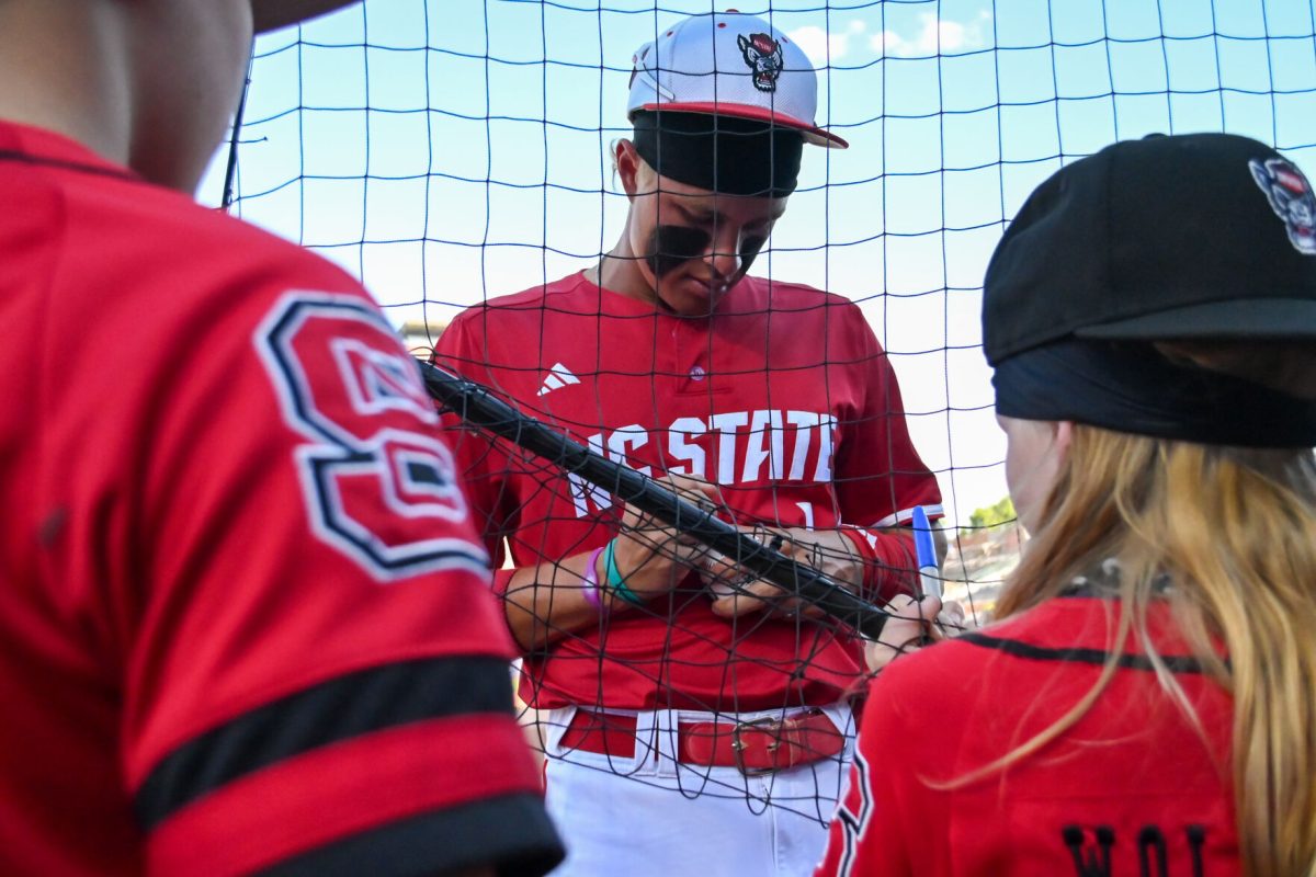 Freshman outfielder Ty Head signs a ball before the game against Clemson at Durham Bulls Athletic Park on Thursday, May 22, 2025. Head had three hits in four at bats. NC State fell to Clemson 7-6.