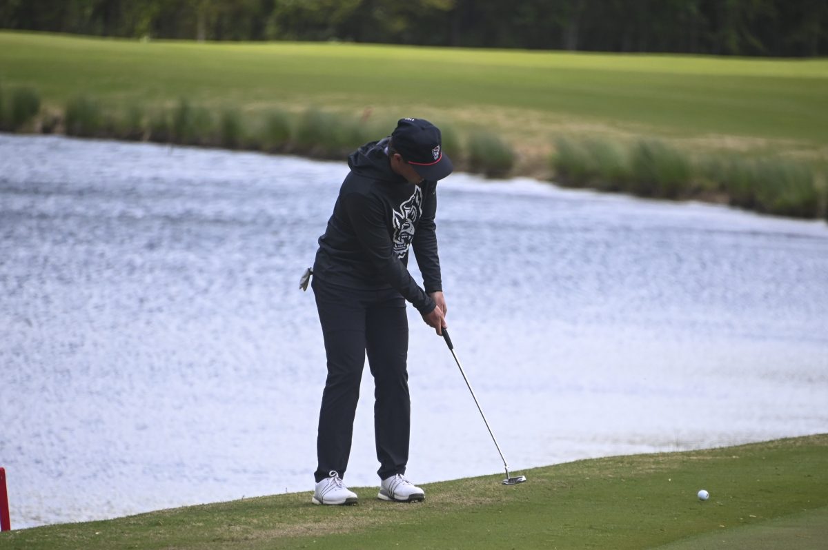 Junior Cade McLaughlin taps his club during the Stitch Intercollegiate golf match on Lonnie Poole Golf Course on Friday, April 12, 2024. McLaughlin finished the first round with 78 points.
