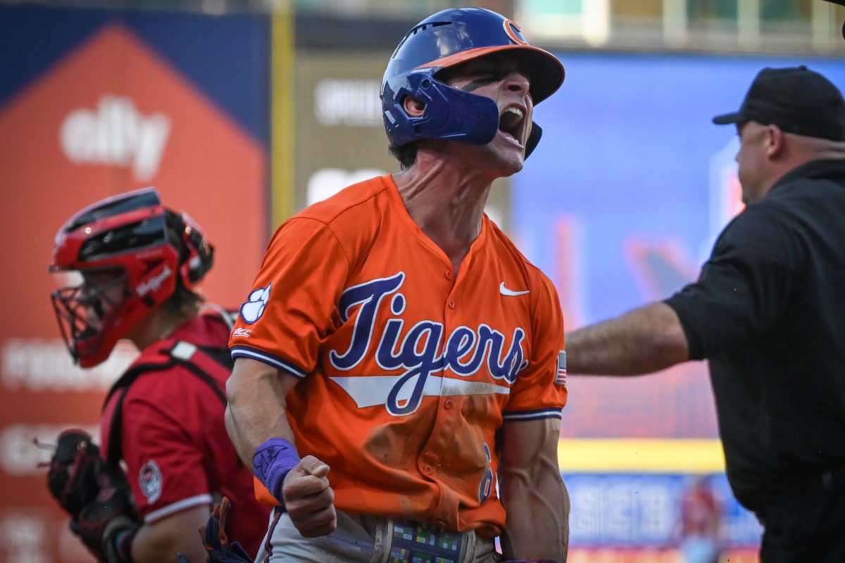 Clemson outfielder Dominic Listi celebrates beating the tag at home from sophomore catcher Alex Sosa against NC State at the Durham Bulls Athletic Park for the quarterfinals of the ACC Baseball Tournament on Thursday, May 22, 2025. The Tigers defeated the Wolfpack 7-6 to advance to the semifinals.