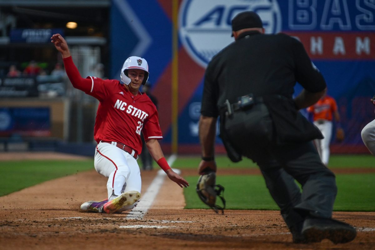 Junior outfielder Josh Hogue slides into home plate during NC State's game against the Clemson Tigers at the Durham Bulls Athletic Park for the quarterfinals of the ACC Baseball Tournament on Thursday, May 22, 2025. The Tigers defeated the Wolfpack 7-6 to advance to the semifinals.
