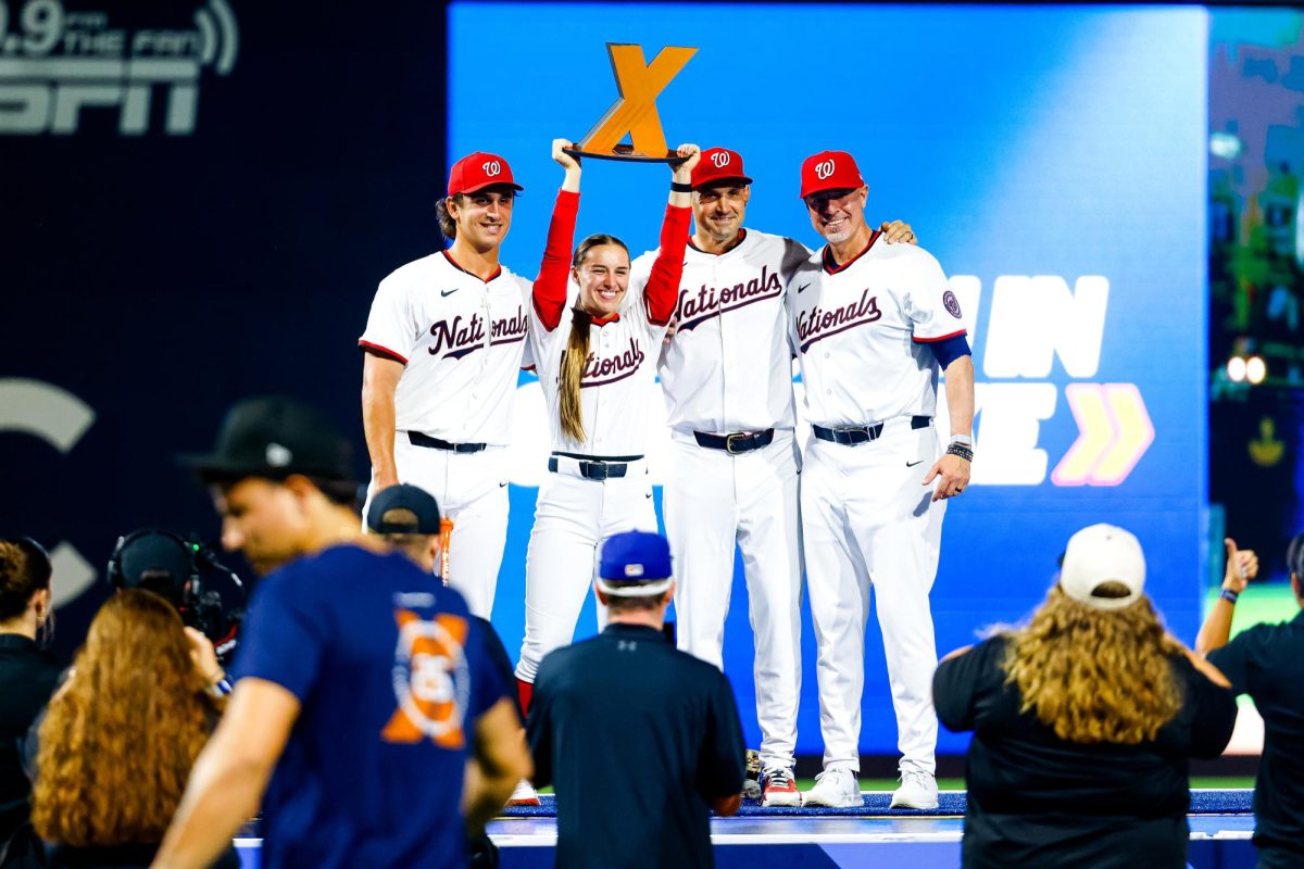 Sophomore NC State infielder Chris McHugh stands on stage with fellow MLB Home Run Derby X champions Ali Newland and Ryan Zimmerman at Durham Bulls Athletic Park on Saturday, Aug. 9, 2025. Home Run Derby X is a new 3-on-3 co-ed competition featuring power hitting and athletic catching. Each event features four teams with each team led by an MLB legend.