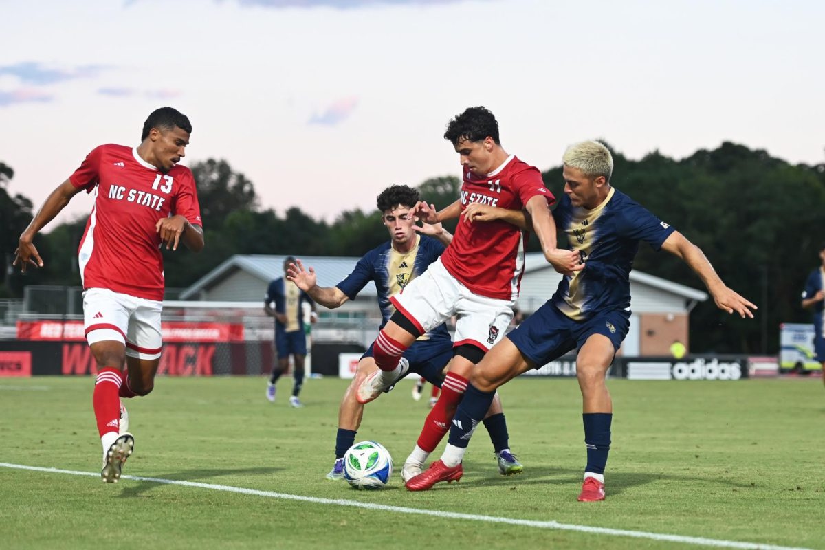 Senior defender Calem Tommy and sophomore forward Frankie DeFrancesco battle opponents for the ball during the match versus FIU at Dail Soccer Field on Sunday, Aug. 24, 2025. NC State beat FIU 2-0.
