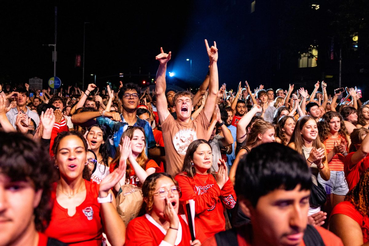 Gray Raney, a first-year studying mechanical engineering, holds up the wolfie hand sign during the Packapalooza concert on Saturday, Aug. 23, 2025. Packapalooza transformed Hillsborough Street into a massive block party, uniting music and Wolfpack pride in one of NC State’s biggest traditions.