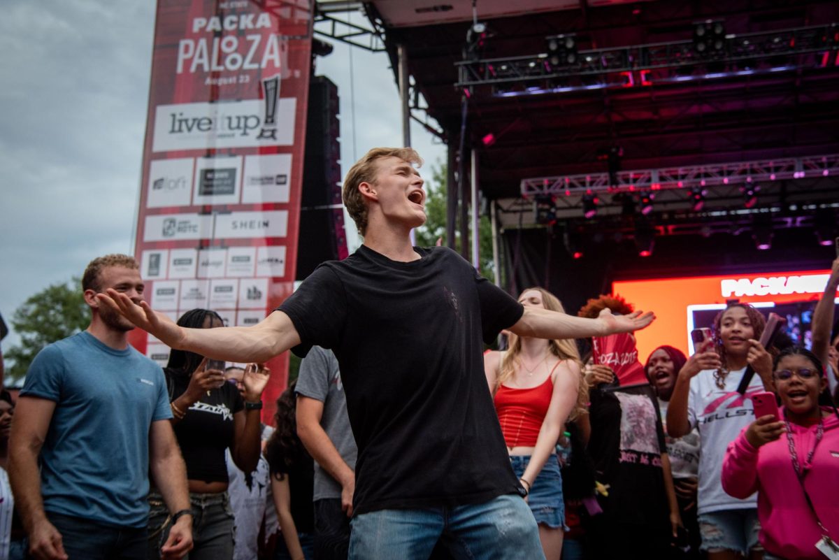William Carter, a second-year in mechanical engineering, sings along to "Baby" by Justin Bieber in a crowd of students during Packapalooza on Saturday, Aug. 23, 2025. Packapalooza™ is NC State’s signature all-day block party and street festival, capping off Wolfpack Welcome Week.