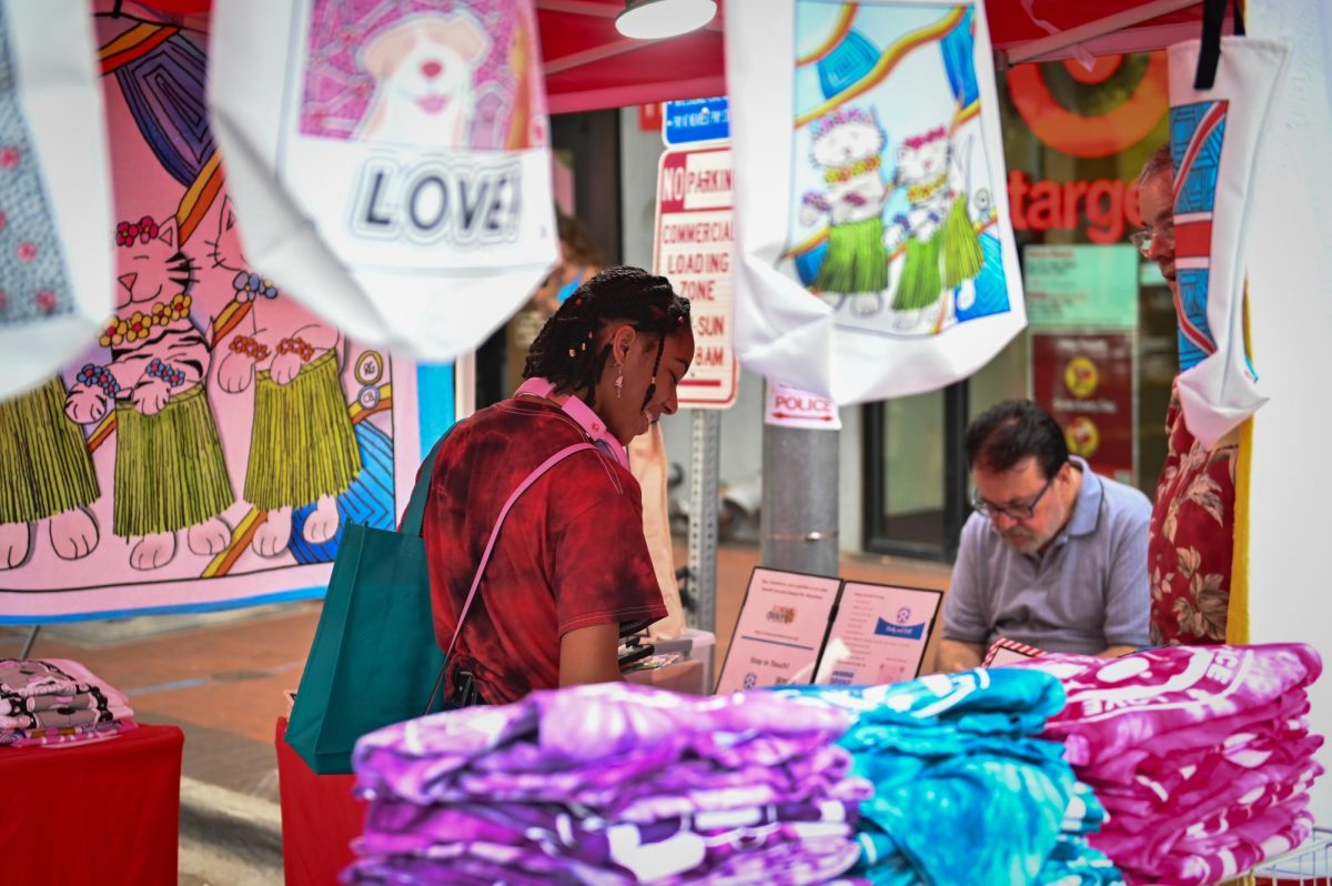 Nyusha Dawkins, a first-year in biochemistry, browses though a local vendor's booth during Packapalooza on Saturday, Aug. 23, 2025. Packapalooza is NC State's annual block party to cap off Wolfpack Welcome Week.