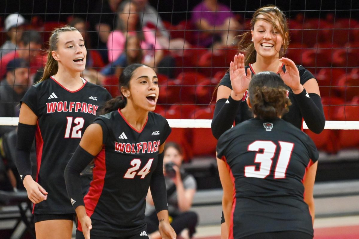 Senior outside hitter Courtney Bryant and senior defensive specialist Sydney Daniels join senior middle blocker Lily Cropper and redshirt-junior defensive specialist Elaisa Villar in celebrating after a kill during the match against Akron in Reynolds Coliseum on Friday, Aug. 29, 2025. Bryant, Daniels, Cropper, and Villar combined for 18 kills. NC State beat Akron Tech 3-2.