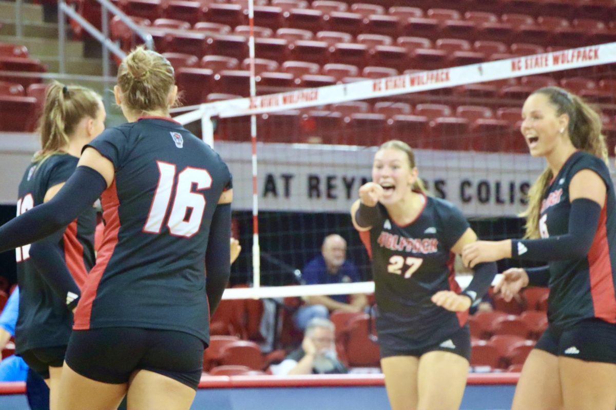 Freshman opposite hitter Rebecca Ring gestures to sophomore setter Ashley Mullen during the game against Akron at Reynolds Coliseum on Friday, Aug. 29, 2025. Mullen recorded one ace and 27 assists. NC State beat Akron 3-2.