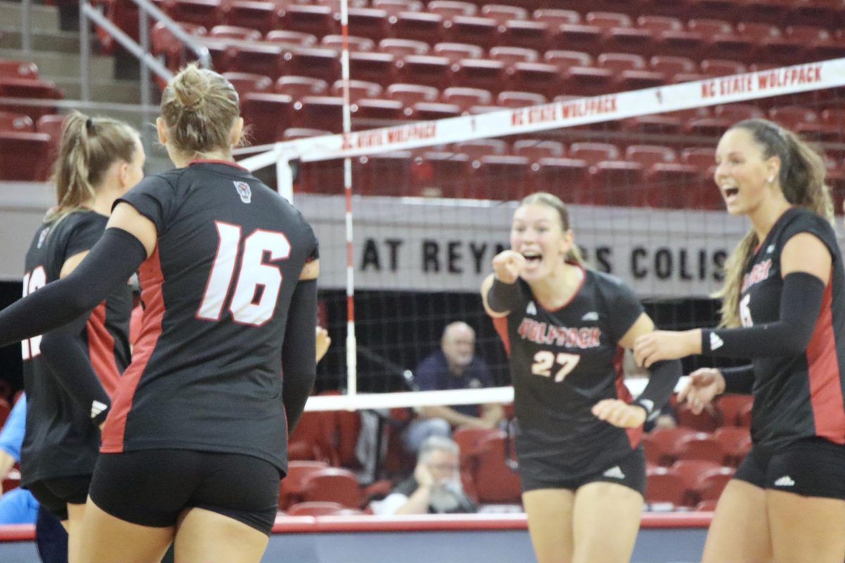 Freshman opposite hitter Rebecca Ring gestures to sophomore setter Ashley Mullen during the game against Akron at Reynolds Coliseum on Friday, Aug. 29, 2025. Mullen recorded one ace and 27 assists. NC State beat Akron 3-2.