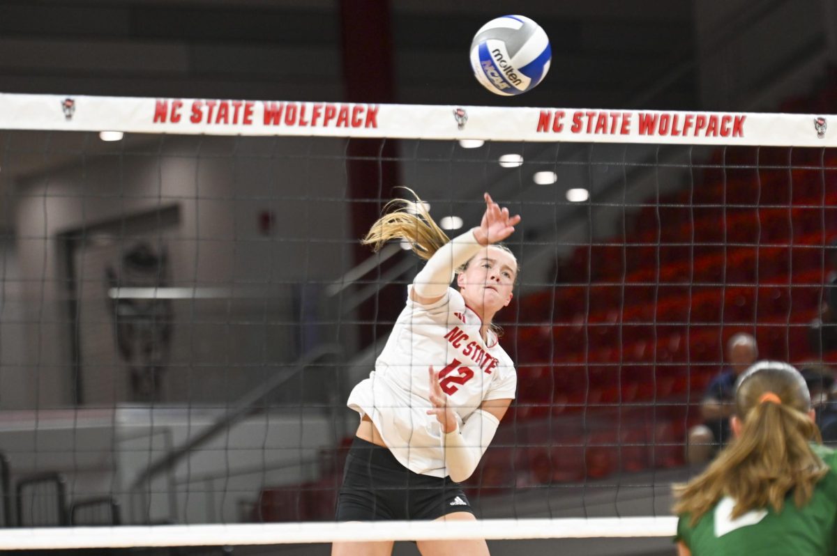 Senior outside hitter Courtney Bryant hits the ball over the net during the volleyball match against Green Bay in Reynolds Coliseum on Saturday, Aug. 30, 2025. Bryant scored 11.5 points. NC State beat Green Bay 3-2.