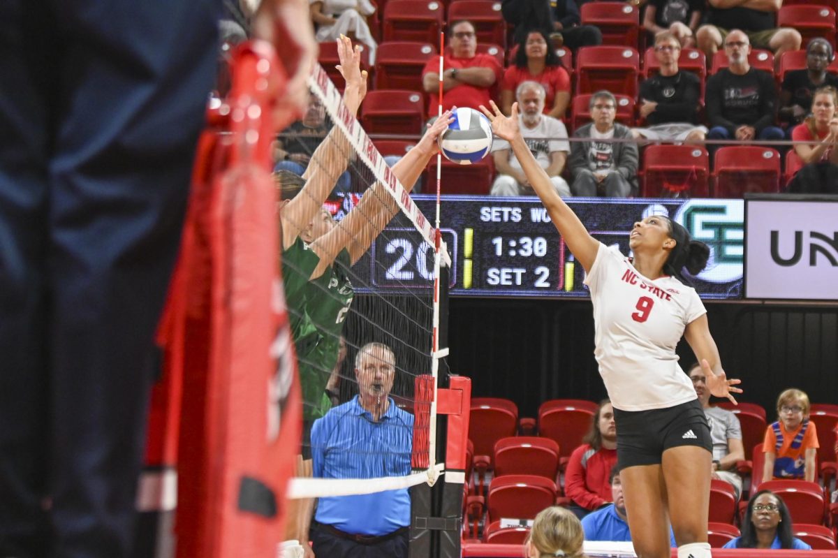 Freshman opposite hitter Sa'Mya Dorsey tips the ball over during the volleyball match against Green Bay in Reynolds Coliseum on Saturday, Aug. 30, 2025. Dorsey had two kills. NC State beat Green Bay 3-2.