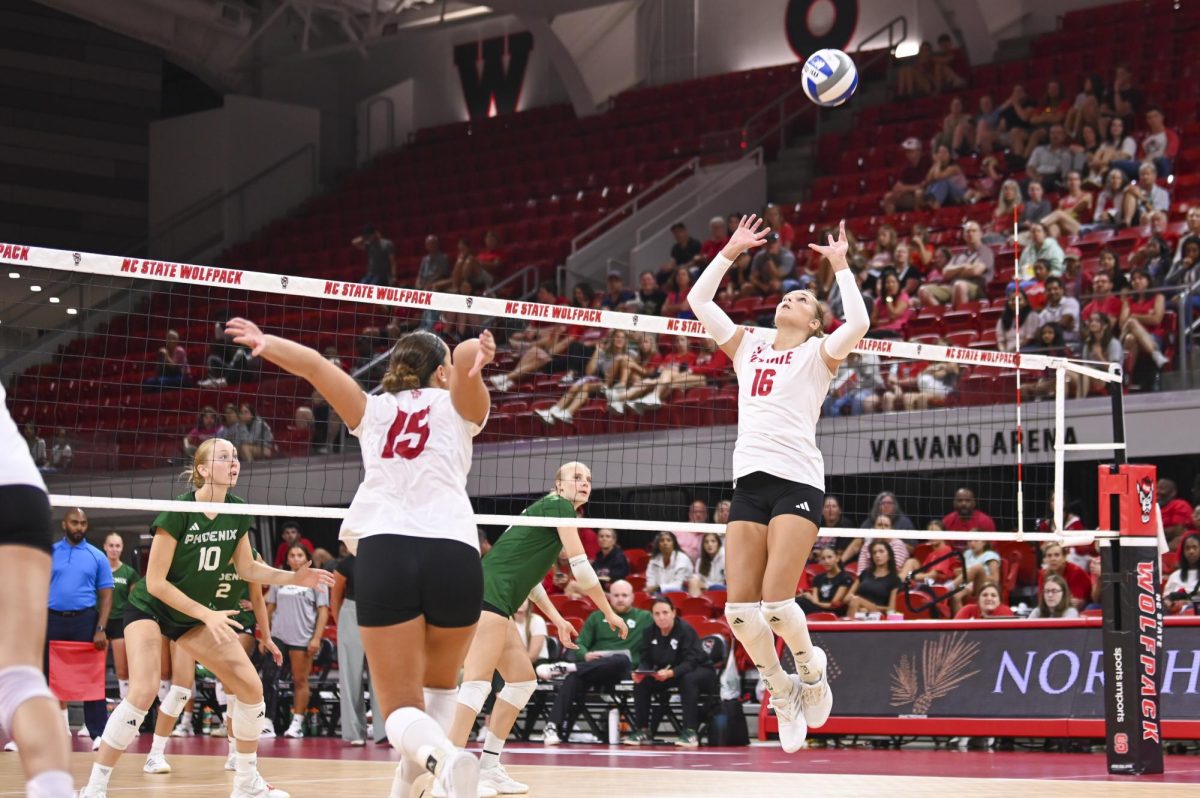 Sophomore setter Ashley Mullen sets the ball for senior middle blocker Lily Cropper during the volleyball match against Green Bay in Reynolds Coliseum on Saturday, Aug. 30, 2025. Mullen had 23 assists. NC State beat Green Bay 3-2.