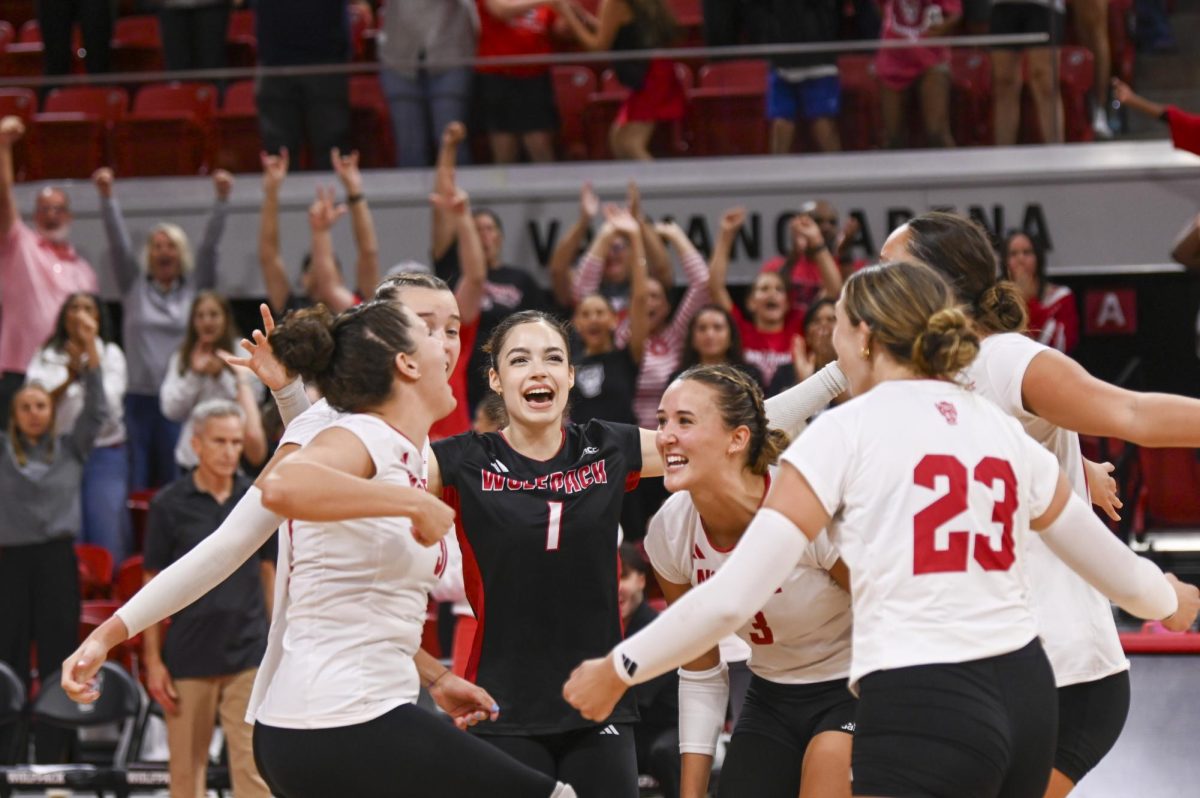 The NC State volleyball team celebrates their win over Green Bay in Reynolds Coliseum in Reynolds Coliseum on Saturday, Aug. 30, 2025. NC State beat Green Bay 3-2.