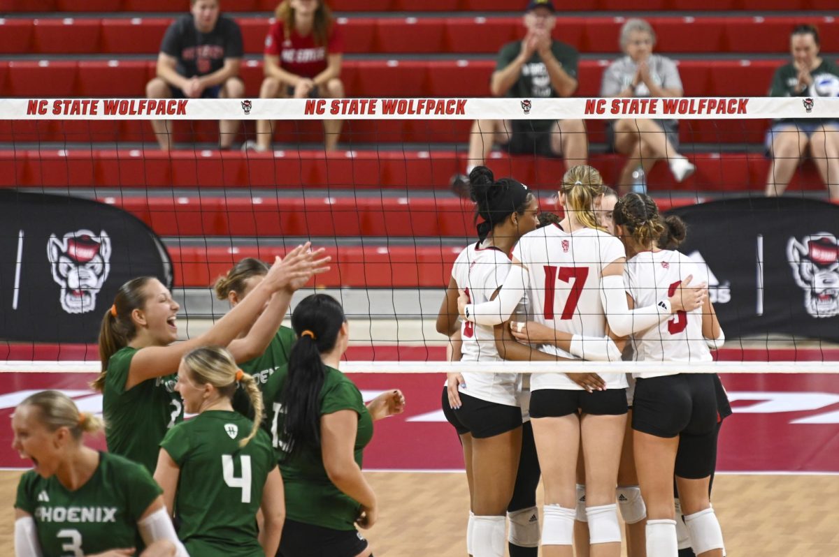 The NC State volleyball team form a huddle after losing during the volleyball match against Green Bay in Reynolds Coliseum on Saturday, Aug. 30, 2025. NC State beat Green Bay 3-2.