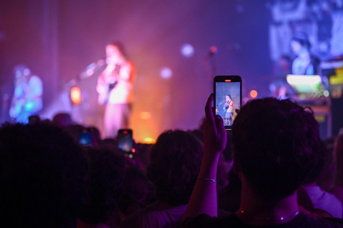 Fan recording The Backseat Lovers from the crowd at The Cat's Cradle in Carrboro on Sept. 17, 2025. The Backseat Lovers are a rock band from Provo, Utah that gained popularity with their hit single “Kilby Girl” in 2019.