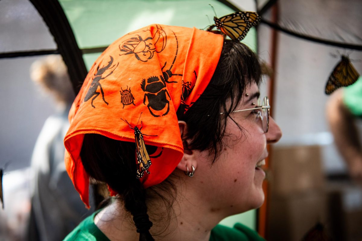 Monarch butterflies rest on Sophia Copeman's insect-themed bandana during BugFest at the North Carolina Museum of Natural Sciences on Saturday, Sept. 20, 2025. At BugFest, many stations featured live exhibits to educate visitors about insects.