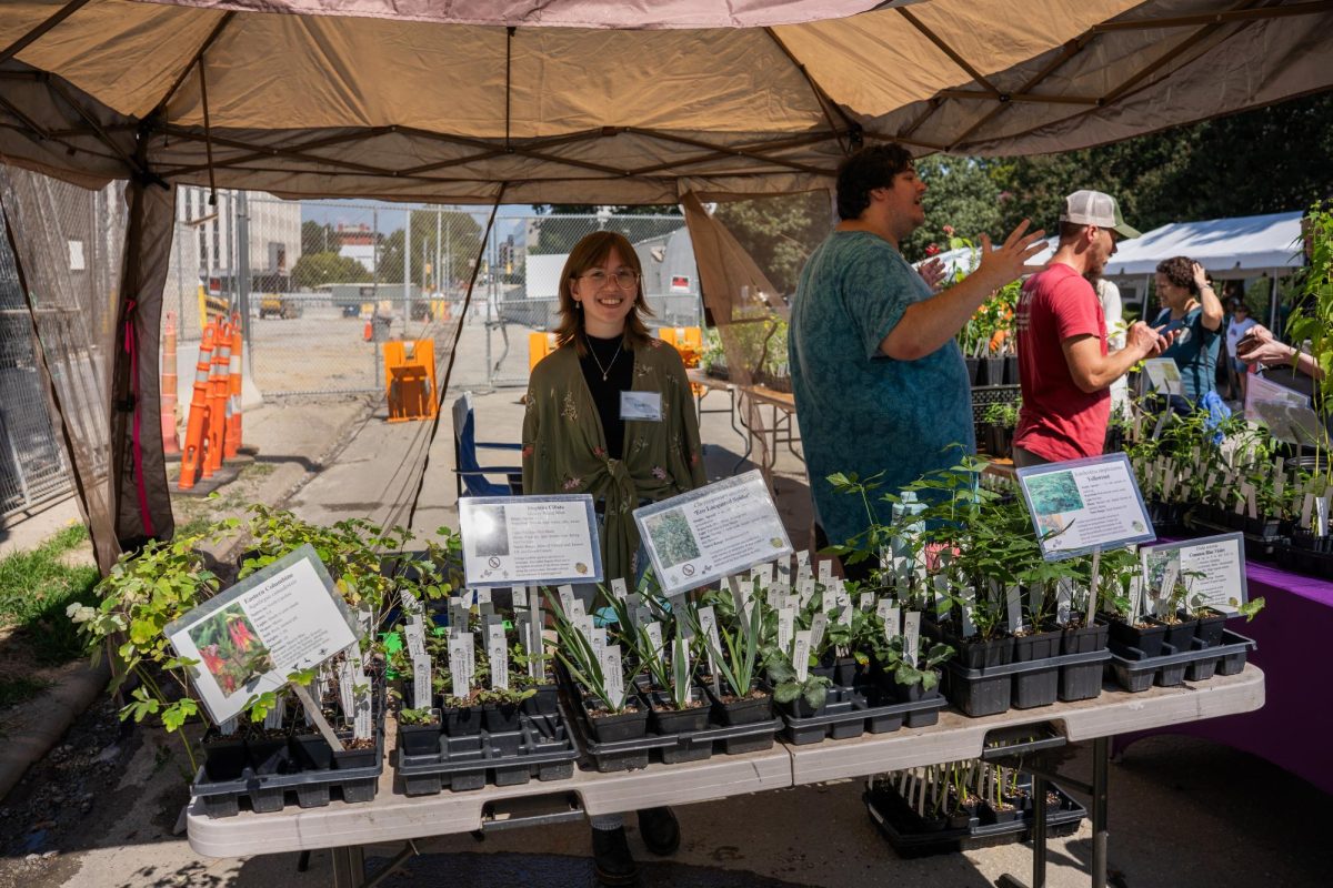 Emily Dettmer poses for a photo with her plants during BugFest at the North Carolina Museum of Natural Sciences on Saturday, Sept. 20, 2025. Bugfest hosted many vendors who provided food, insects, and plants.