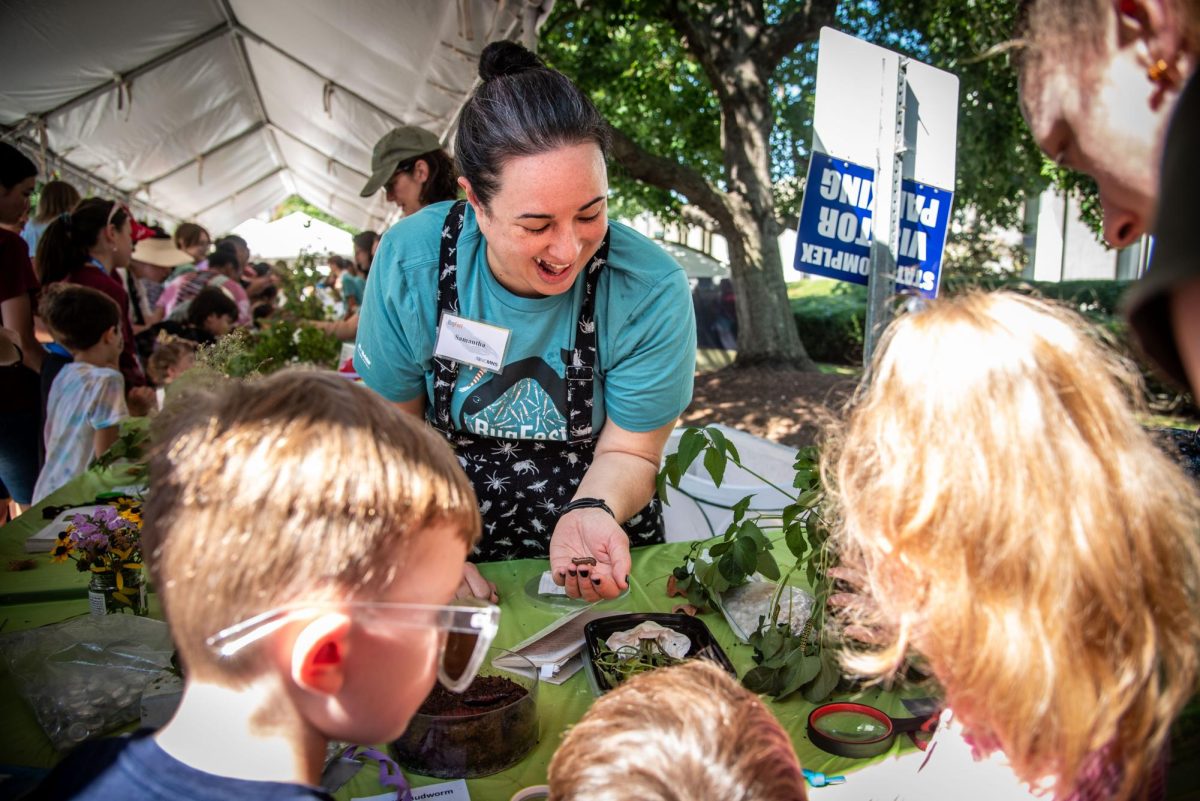 Samantha Frigerio, coordinator of accessibility for the North Carolina Museum of Natural Sciences, teaches children about Armyworms during BugFest on Saturday, Sept. 20, 2025. At BugFest, many vendors and conservationists set up stations to educate about the bug world.