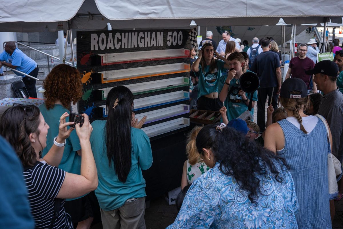 BugFest visitors watch the "Roachingham 500" during BugFest at the North Carolina Museum of Natural Sciences on Saturday, Sept. 20, 2025. At the event participants learned about various bugs through visual displays.
