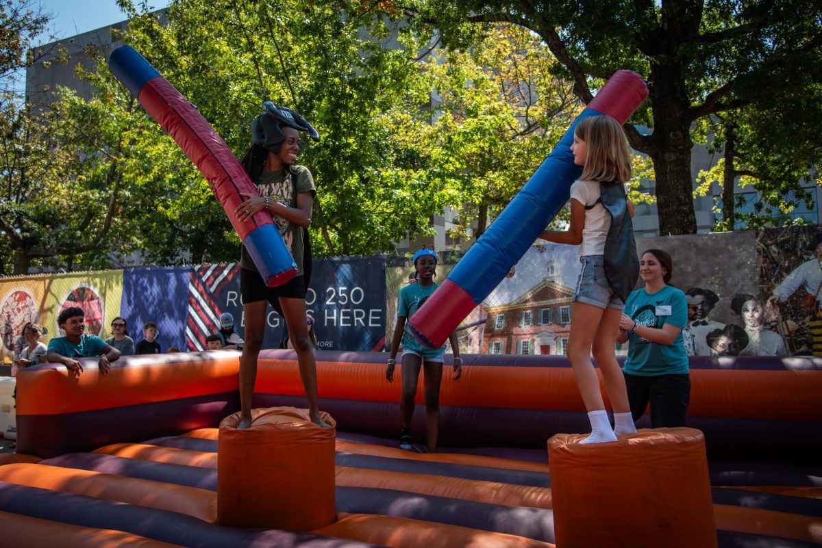 Visitors participate in a tube game during BugFest at the North Carolina Museum of Natural Sciences on Saturday, Sept. 20, 2025. Participants lined the street to engage in games and educational activities centered around the world of insects at BugFest.