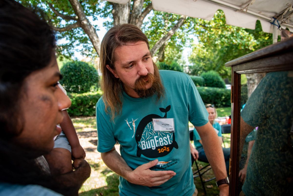 Marcus Ullberg, a beekeeper for Five County Beekepers, talks to BugFest visitors about honey production during the event on Saturday, Sept. 20, 2025. At BugFest, many vendors and conservationists set up stations to educate about the bug world.