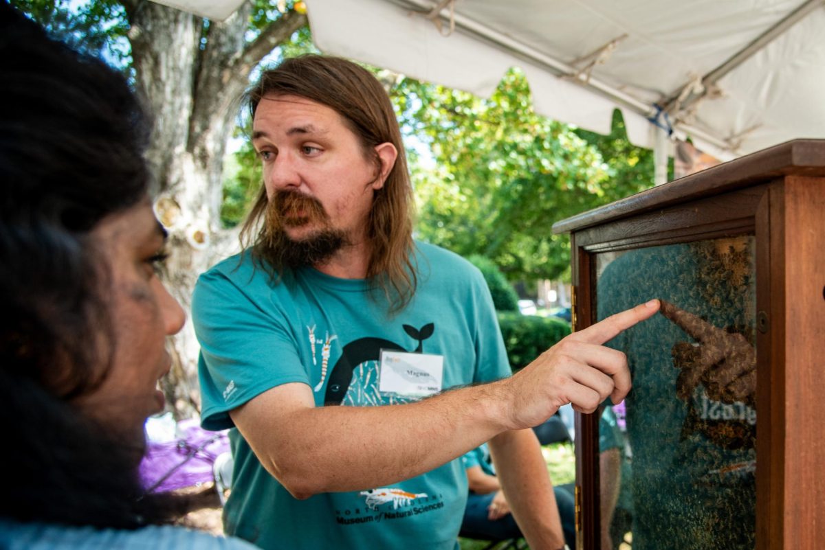 Marcus Ullberg, a beekeeper for Five County Beekepers, talks to BugFest visitors about honey production during the event on Saturday, Sept. 20, 2025. At BugFest, many vendors and conservationists set up stations to educate about the bug world.