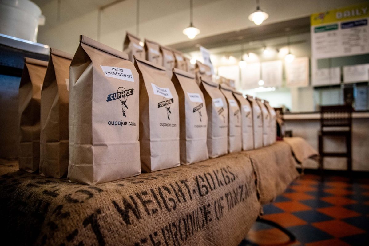 Bagged coffee shelved in Cup A Joe Mission Valley on Saturday, Sept. 27, 2025. After a three year closure, the store reopened on Aug. 11, 2025.