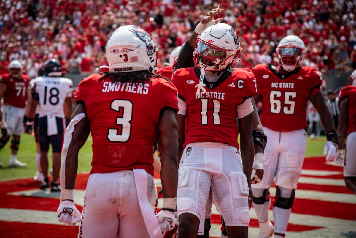 Sophomore quarterback CJ Bailey and redshirt sophomore runningback Daylen "Hollywood" Smothers celebrate a touchdown during the game against Virginia in Carter-Finley Stadium on Saturday, Sep. 6, 2025. The Wolfpack beat the Cavaliers 35-31.