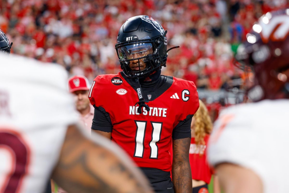 Sophomore quarterback CJ Bailey looks at the referee during the captain's coin toss before kickoff during the game against Virginia Tech on Saturday, Sept. 27, 2025. Bailey threw for 240 yards with two touchdowns. NC State lost to Virginia Tech 23-21.