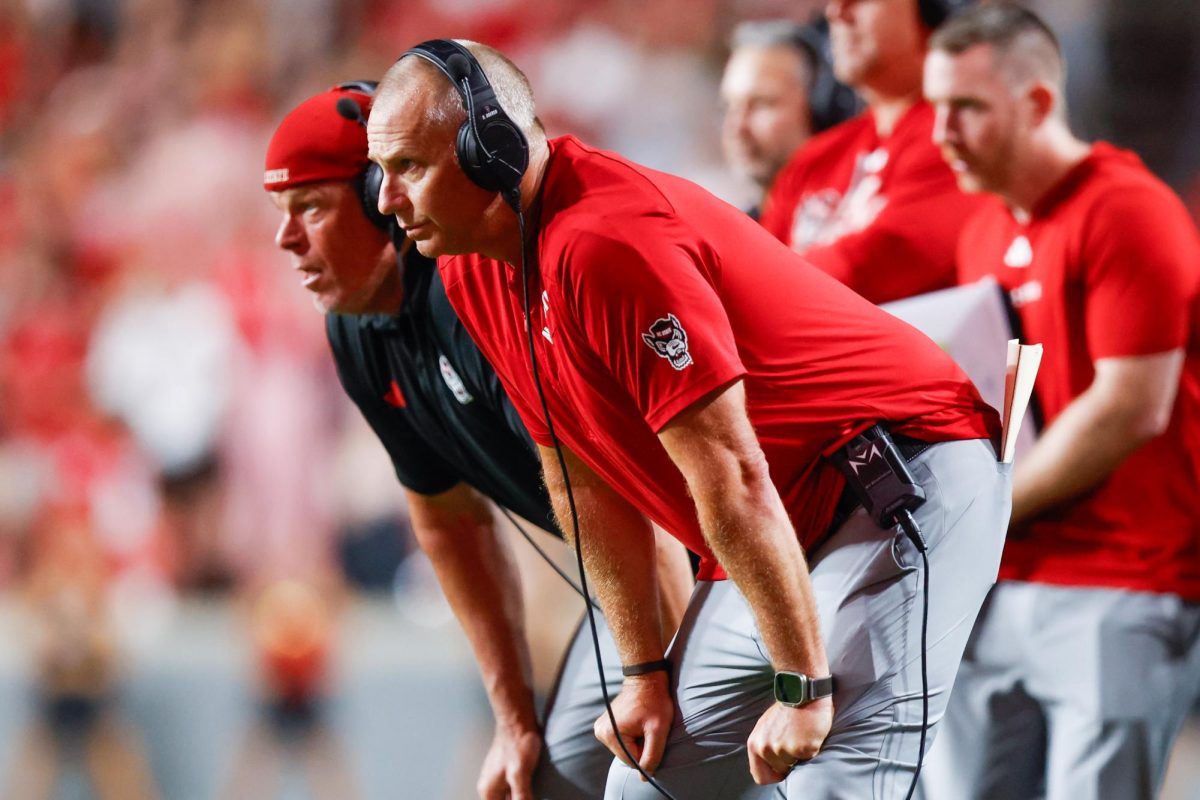 Head Coach Dave Doeren leans over while watching a rush play during the game against Virginia Tech on Saturday, Sept. 27, 2025. NC State lost to Virginia Tech 23-21.