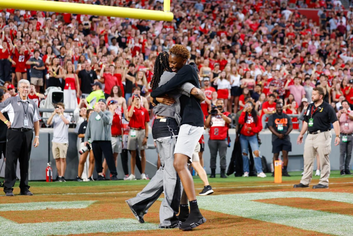 Alpha Wolves Saniya Rivers and Aziaha James hug after getting the crowd hype before the game against Virginia Tech on Saturday, Sept. 27, 2025. NC State lost to Virginia Tech 23-21.