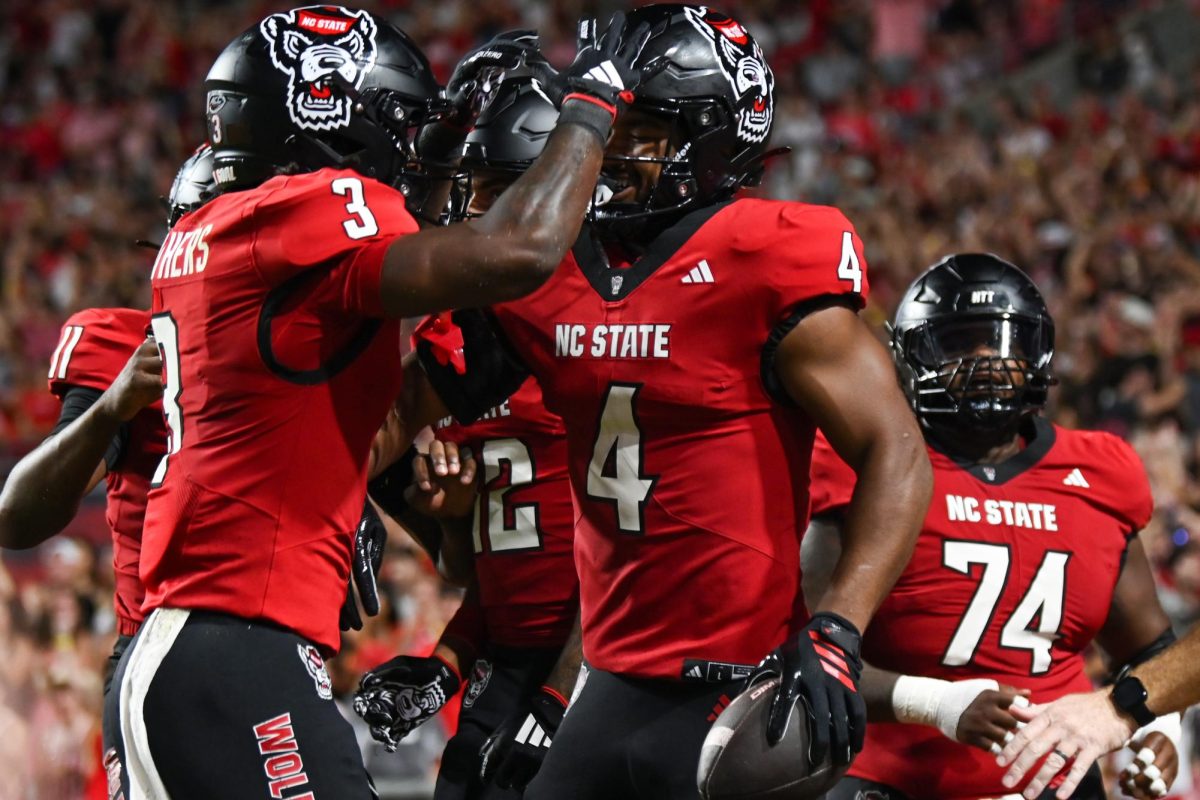 Redshirt sophomore Hollywood Smothers and redshirt freshman Jayden Scott celebrate Scott's touchdown during the game against Virginia Tech at Carter-Finley Stadium on Saturday, Sept. 27, 2025. Smothers had 16 carries and Scott had one touchdown. The Wolfpack fell to the Hokies 23-21.