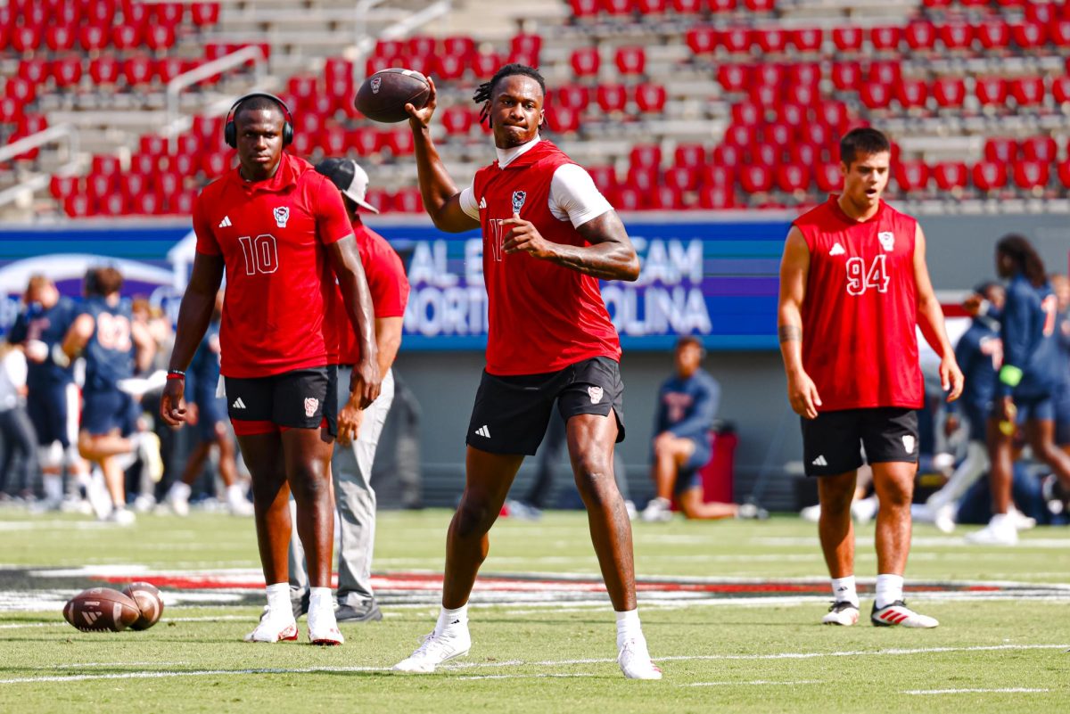 Sophomore quarterback CJ Bailey warms up before the game against Virginia in Carter-Finley Stadium on Saturday, Sept. 6, 2025. Bailey had 200 passing yards while throwing for a touchdown. The Wolfpack beat the Cavaliers 35-31.
