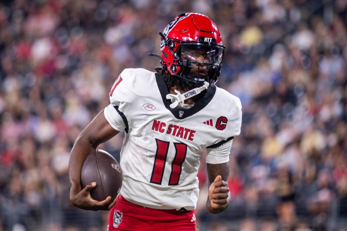 Sophomore quarterback CJ Bailey rushes the ball during the game against Wake Forest in Allegacy Stadium on Thursday, Sept. 11, 2025. Baliey threw for 201 yards and three touchdowns. The Wolfpack beat the Demon Deacons 34-24.